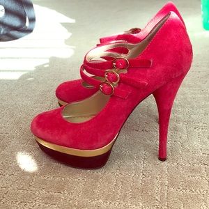 Red black and gold platform Mary Jane pumps.
